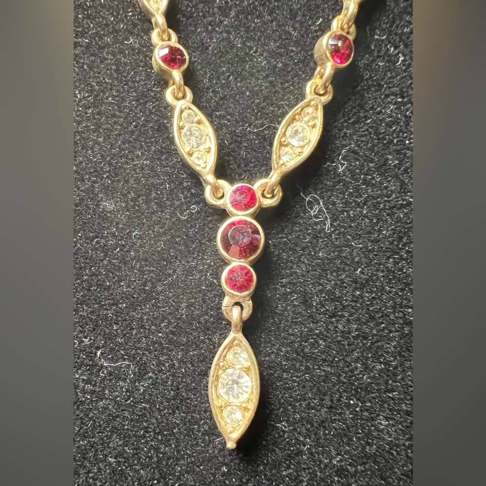 Goldtone chain with red stones and zirconia.
